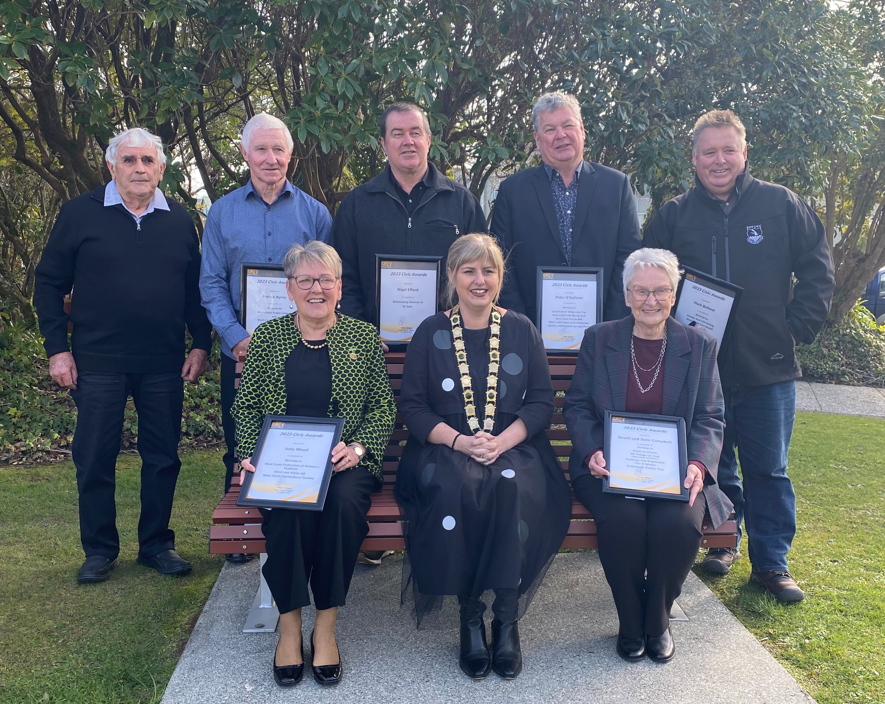 Civic award recipients with the Mayor holding their awards